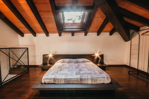 a bedroom with a large bed in a room with wooden ceilings at Bigattera Apartments in Varese