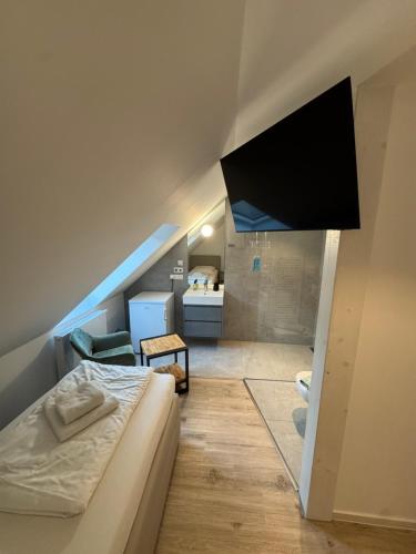 a room with a bed and a flat screen tv at Restaurant Trocadero in Hannover