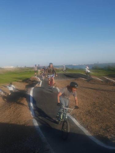 a group of people riding bikes on a road at Mobil home IRM Excellence dans parc Natura 2000 Lac des rêves piscine ect sous fun pass in Lattes