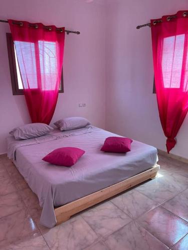 a bedroom with a large bed with pink curtains at Villa Privée 1 Marrakech Piscine Chauffée En Option Sans Vis-à-vis pour famille et couple marié uniquement in Marrakech