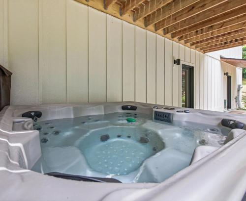 a hot tub in the middle of a house at BRAND NEW 10 Min to Downtown and Private HOT TUB and Arcade in Asheville