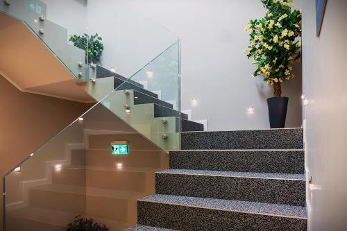 a glass staircase in a building with a sign on it at Liro Hotel Oberhausen in Oberhausen
