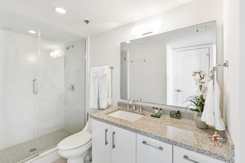 a bathroom with a sink and a toilet and a shower at Bahia Mar-Solare Tower, Beachfront Resort with Two Pools in South Padre Island