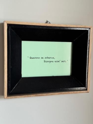 a picture of a picture frame with a writing on it at Casa Acilia Luxury Apartment in Acilia