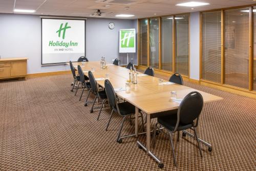 a conference room with a long table and chairs at Holiday Inn Preston by IHG in Preston