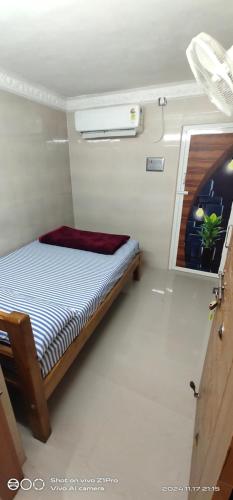 a bedroom with a bed in a small room at Shree chendur Residency tvm in Tiruvannāmalai