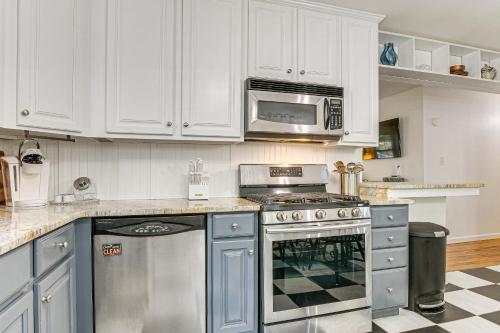 a kitchen with a stove and a microwave at 4 Mi to Falls Lake Dog-Friendly Wake Forest Home in Wake Forest