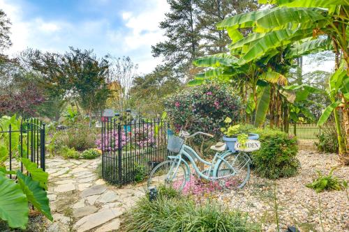 a blue bike parked in a garden with flowers at 4 Mi to Falls Lake Dog-Friendly Wake Forest Home in Wake Forest
