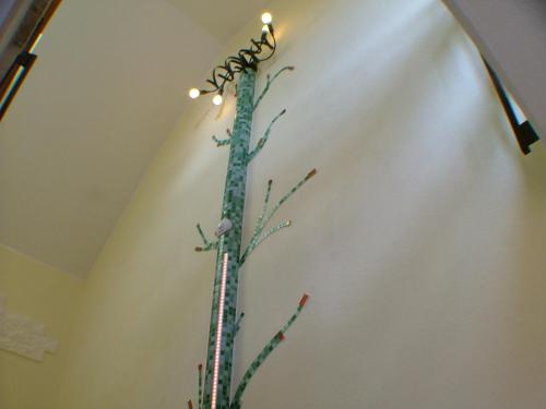 a plant with lights on top of a wall at Hotel garni Pension Zur Lutherstadt in Lutherstadt Eisleben