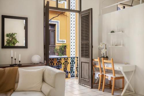 a living room with a couch and a desk at Spanish Old San Juan Penthouse in San Juan