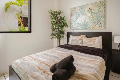 a bedroom with a bed with a stuffed animal on it at Spanish Old San Juan Penthouse in San Juan