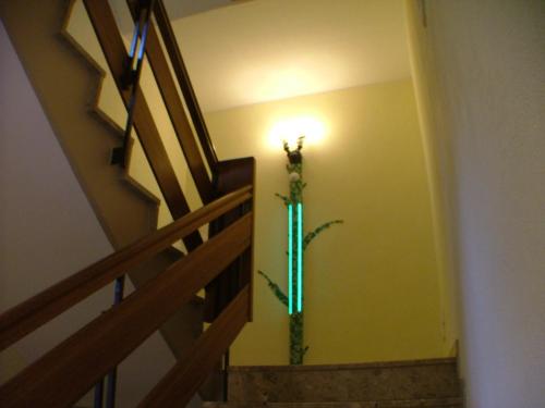 a light in a hallway with a christmas tree on the wall at Hotel garni Pension Zur Lutherstadt in Lutherstadt Eisleben