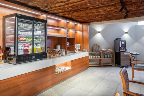 a kitchen with a counter with a refrigerator at Playa Surf CBbC Hotel in El Médano