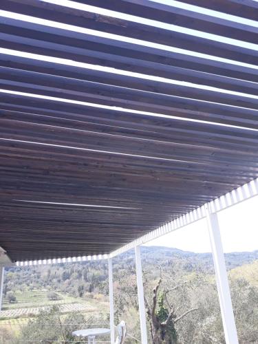 awning over a porch with a view of the mountains at Holiday Home Matthäus am Corfutrail, Ferienoase im Olivenhain 3 km zum Meer in Giannádes
