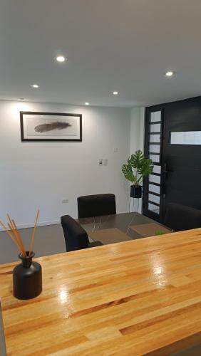 a meeting room with a wooden table and chairs at Complejo "Casa Roca mdq" in Mar del Plata