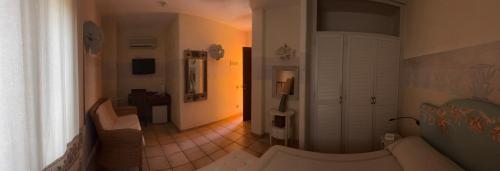 a living room with a couch and a hallway at Villa Madau in Pula