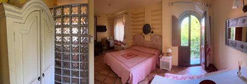 a bedroom with a bed and a room with a window at Villa Madau in Pula