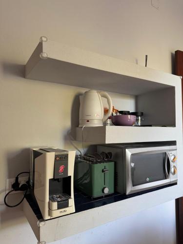 a kitchen with a microwave and a toaster oven at Casa Archi in Cefalù