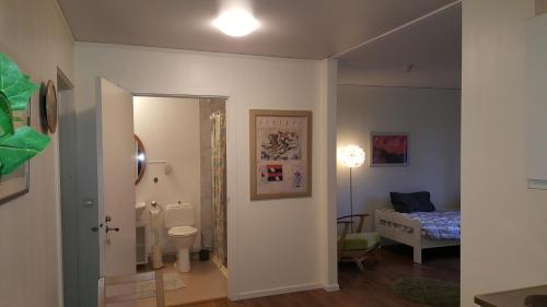 a room with a bathroom and a bedroom with a bed at Ekhult Apartments - Ground Floor - Garden and Lake View in Ulricehamn
