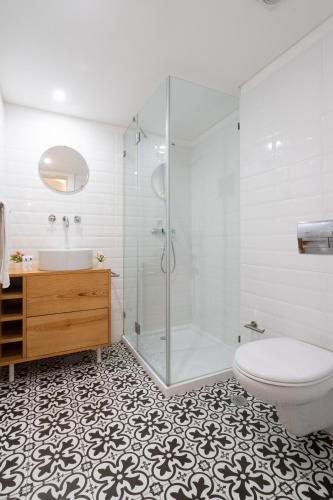 a bathroom with a shower and a toilet and a sink at Host Wise - Large Colourful Flats - Ace Location in Vila Nova de Gaia
