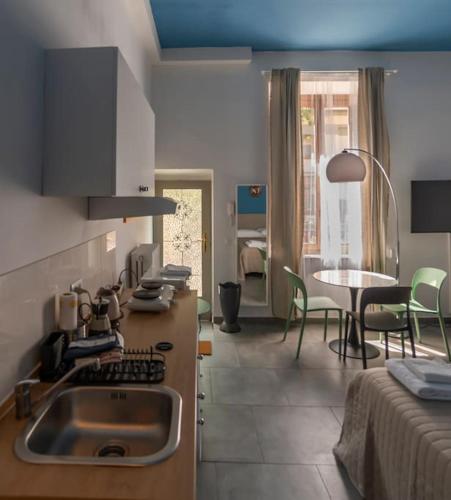 a kitchen with a sink and a table with chairs at Nice Studio apartment in Prato