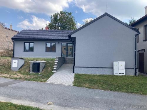a small white house with a driveway at apartmán Fénix in Buková