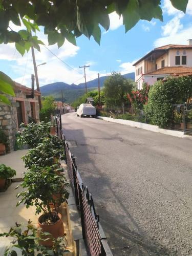 a street with a fence on the side of the road at Traditional house at Pelion seaside in Agria