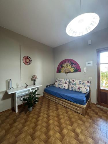 a bedroom with a bed and a table in it at Casa Archi in Cefalù