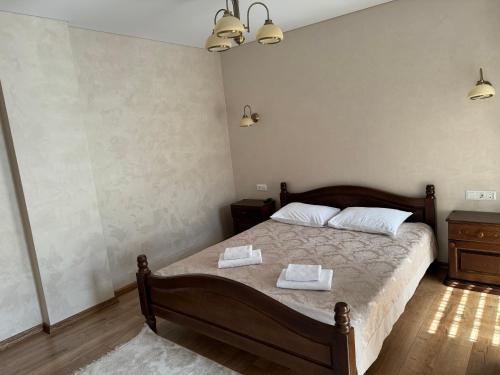 a bedroom with a bed with two towels on it at Continental SPA Resort in Bukovel