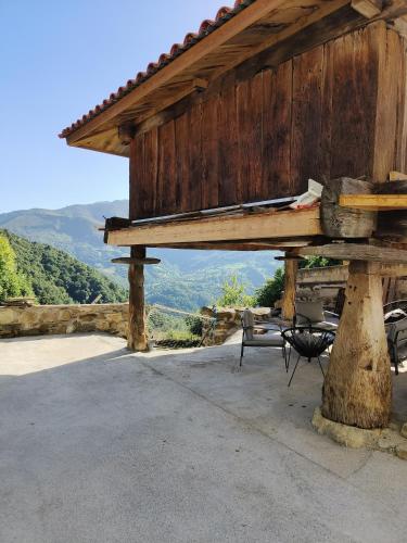 a wooden pavilion with chairs and a table with a view at Quirós Villa Tranquila de Salcedo 2 in La Villa