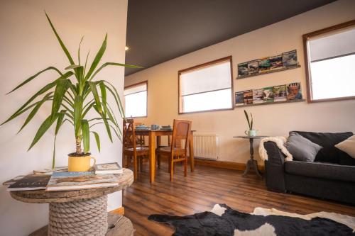 a living room with a couch and a table at Pristine Patagonia Hotel in Puerto Natales