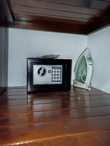 a microwave and a phone sitting on a wooden floor at Arenal Dreams House in Fortuna