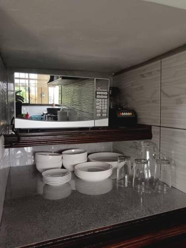 a kitchen with three toilets and a microwave at Arenal Dreams House in Fortuna