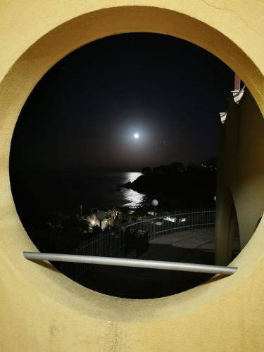 a view of the ocean from a window at night at Casa Archi in Cefalù
