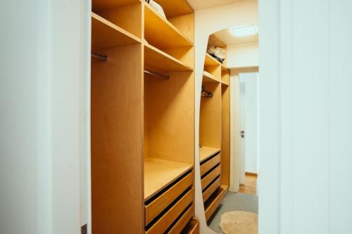 a walk in closet with brown walls and shelves at Grand Sea View Apartment 3' from Kavouri Beach in Athens
