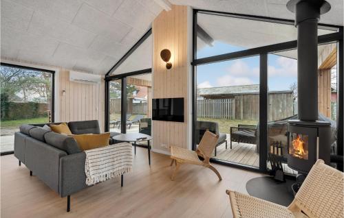 a living room with a couch and a fireplace at Nice Home In Ebeltoft With Sauna in Ebeltoft