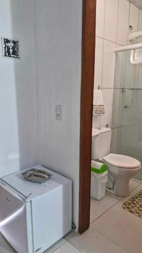 a white bathroom with a toilet and a sink at Solar de Bonito in Bonito