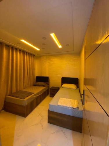 a bedroom with two beds and a glass wall at Luxe building in Oujda