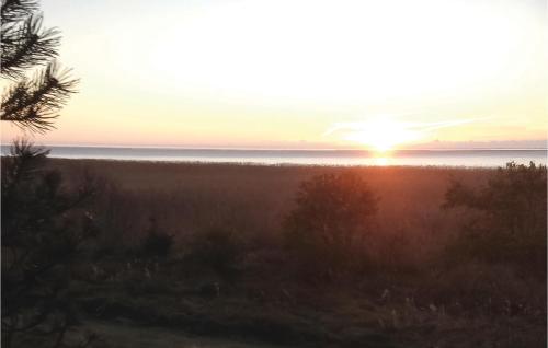 a sunset over a field with the ocean at Stunning Home In Skjern With Kitchen in Lem