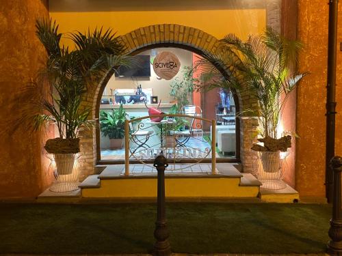 an archway with two potted plants in front of a store at Villa Madau in Pula