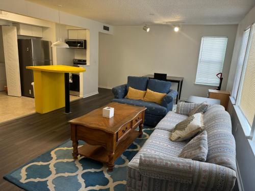 a living room with a couch and a table at A cozy place near UF in Gainesville