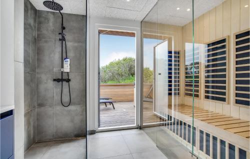 a bathroom with a shower with a glass door at Nice Home In Hjørring With Sauna in Hjørring