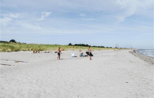a group of people playing on the beach at Awesome Home In Grenaa With Kitchen in Grenå