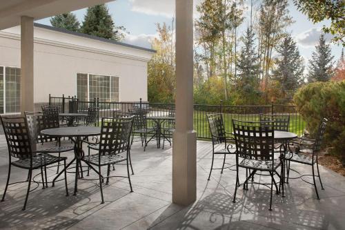 a patio with tables and chairs and a fence at Holiday Inn Express Spokane Airport by IHG in Spokane