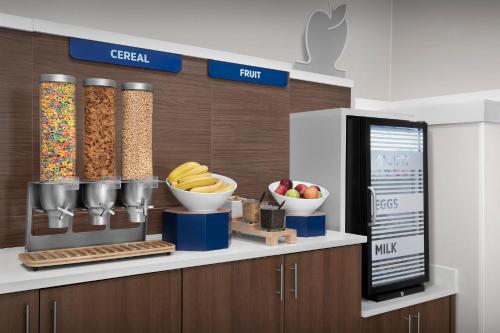a counter with bowls of cereal and fruit on it at Holiday Inn Express Spokane Airport by IHG in Spokane