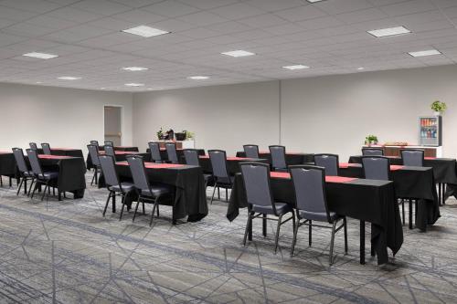 a conference room with black tables and chairs at Holiday Inn Express Spokane Airport by IHG in Spokane