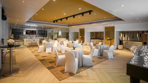 a banquet hall with white chairs and tables at InterContinental Marine Drive Mumbai by IHG in Mumbai