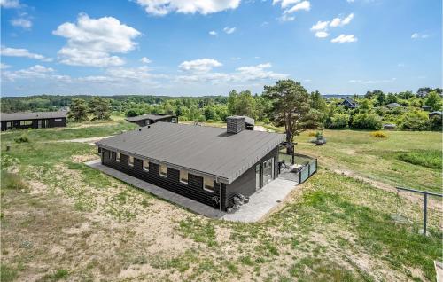 an overhead view of a black house in a field at Beautiful Home In Ebeltoft in Ebeltoft