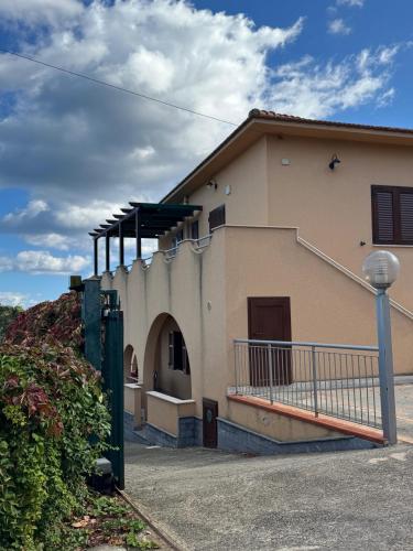 a building with a porch and a fence in front of it at Casa Archi in Cefalù
