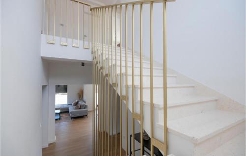 a staircase in a house with white walls and wood floors at Amazing Home In Grubine With Sauna in Grubine
